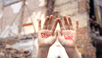 Slogan of peace without war is written on the woman's hand in red stop war. High quality photo. The concept of No war, stop the war, peace. Copy space.