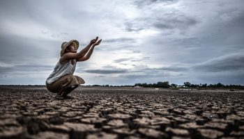 A woman is sitting asking for rain in the dry season,global warming